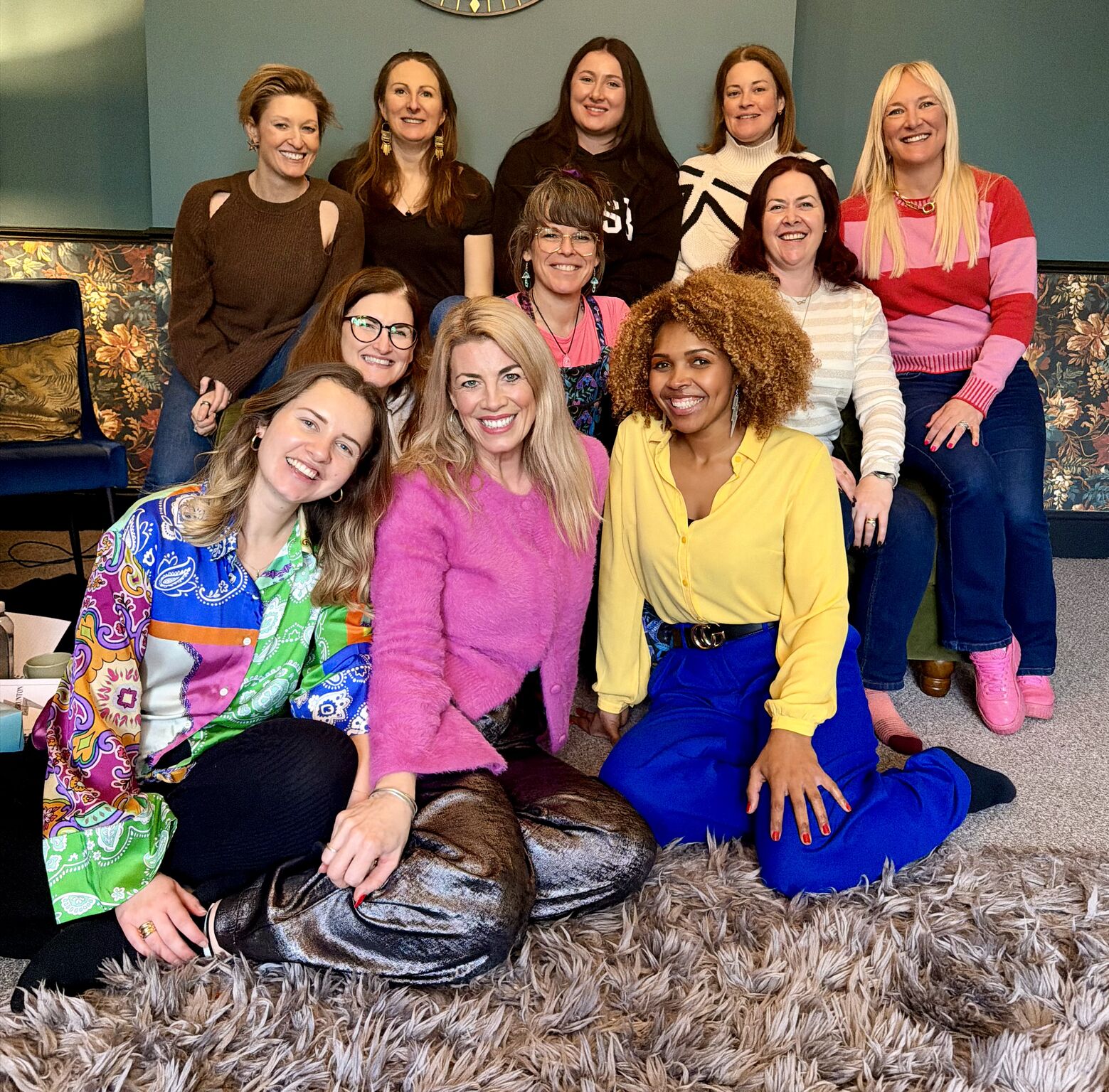 Laura with a small group of women together in a colourful room